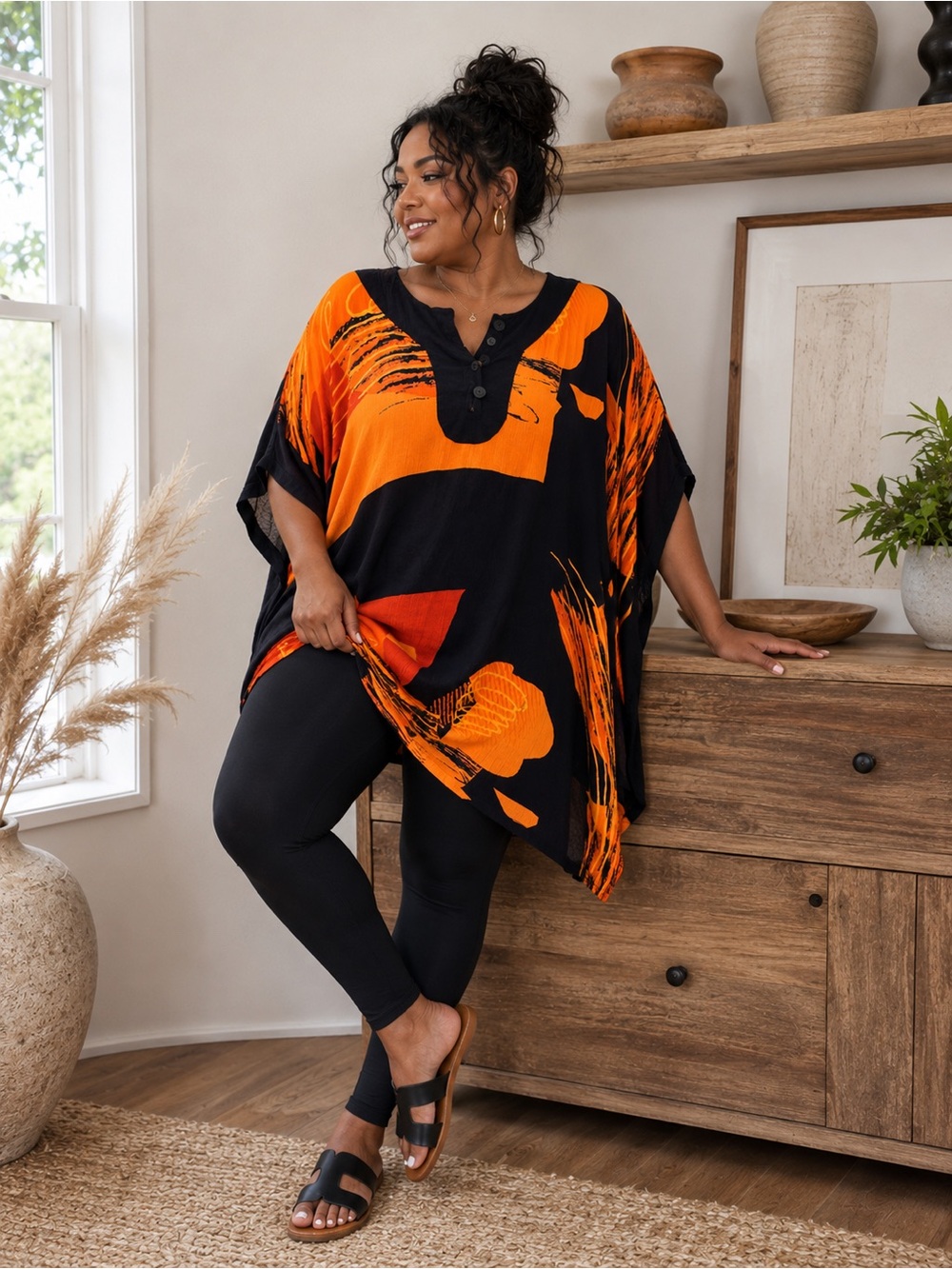 Plus Size Black Tunic with Bold Orange Abstract Print